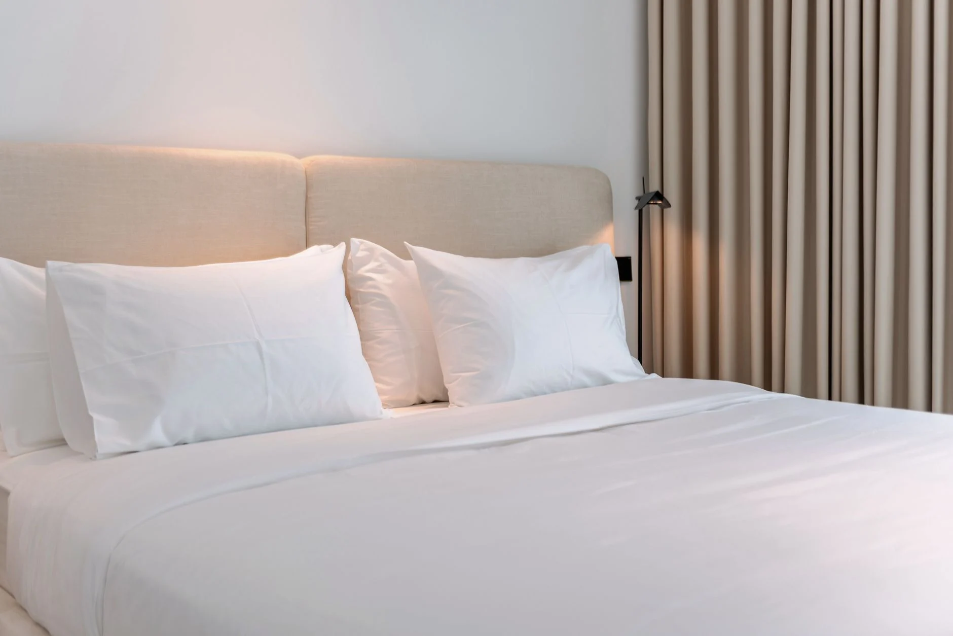Inviting modern bedroom with beige accents, perfect for a cozy vacation rental stay.
