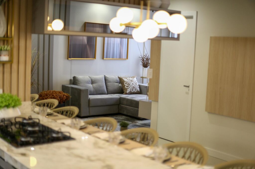 A stylish and elegant modern living room with a gray sofa and chic decor.