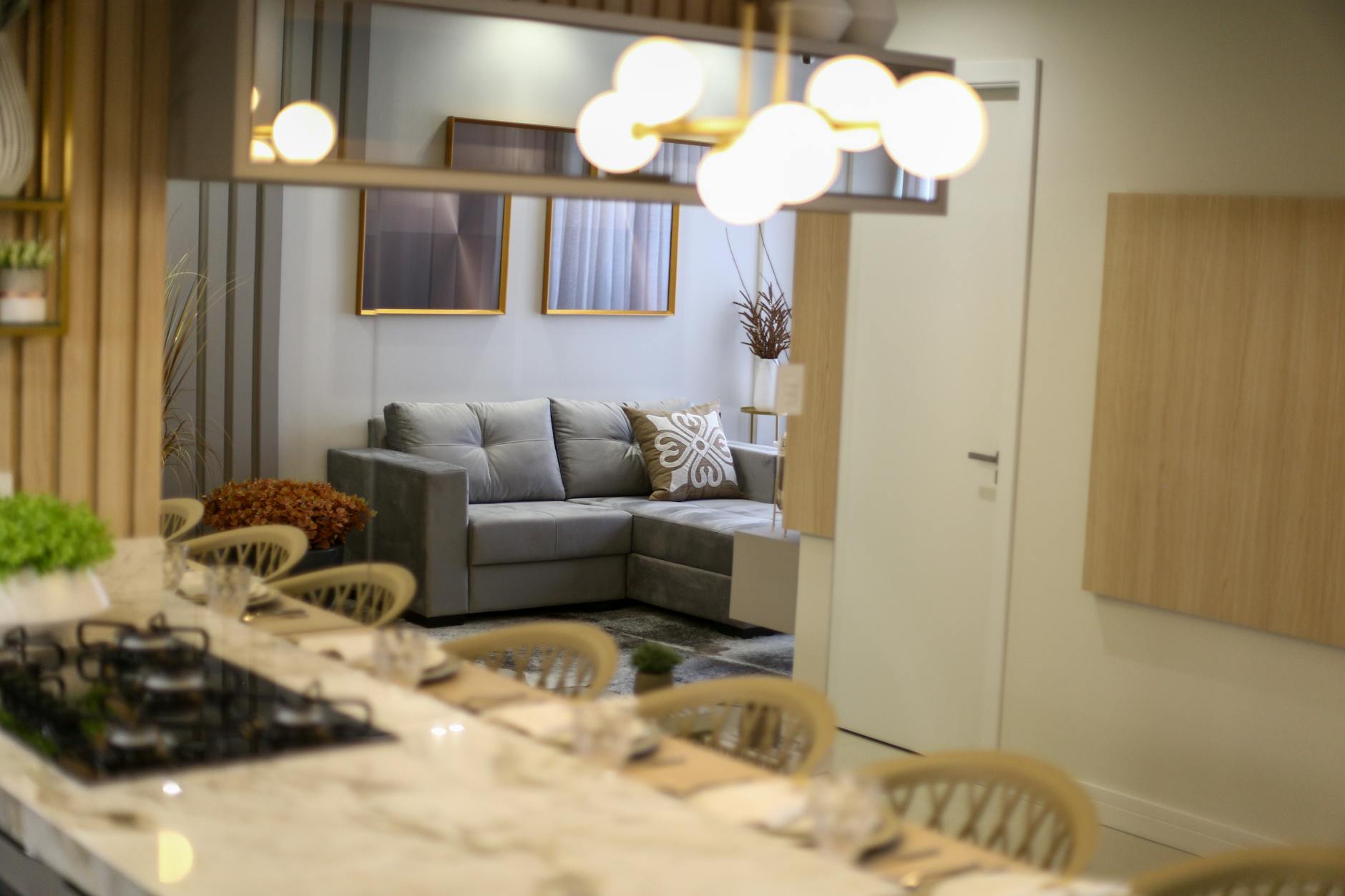 A stylish and elegant modern living room with a gray sofa and chic decor.