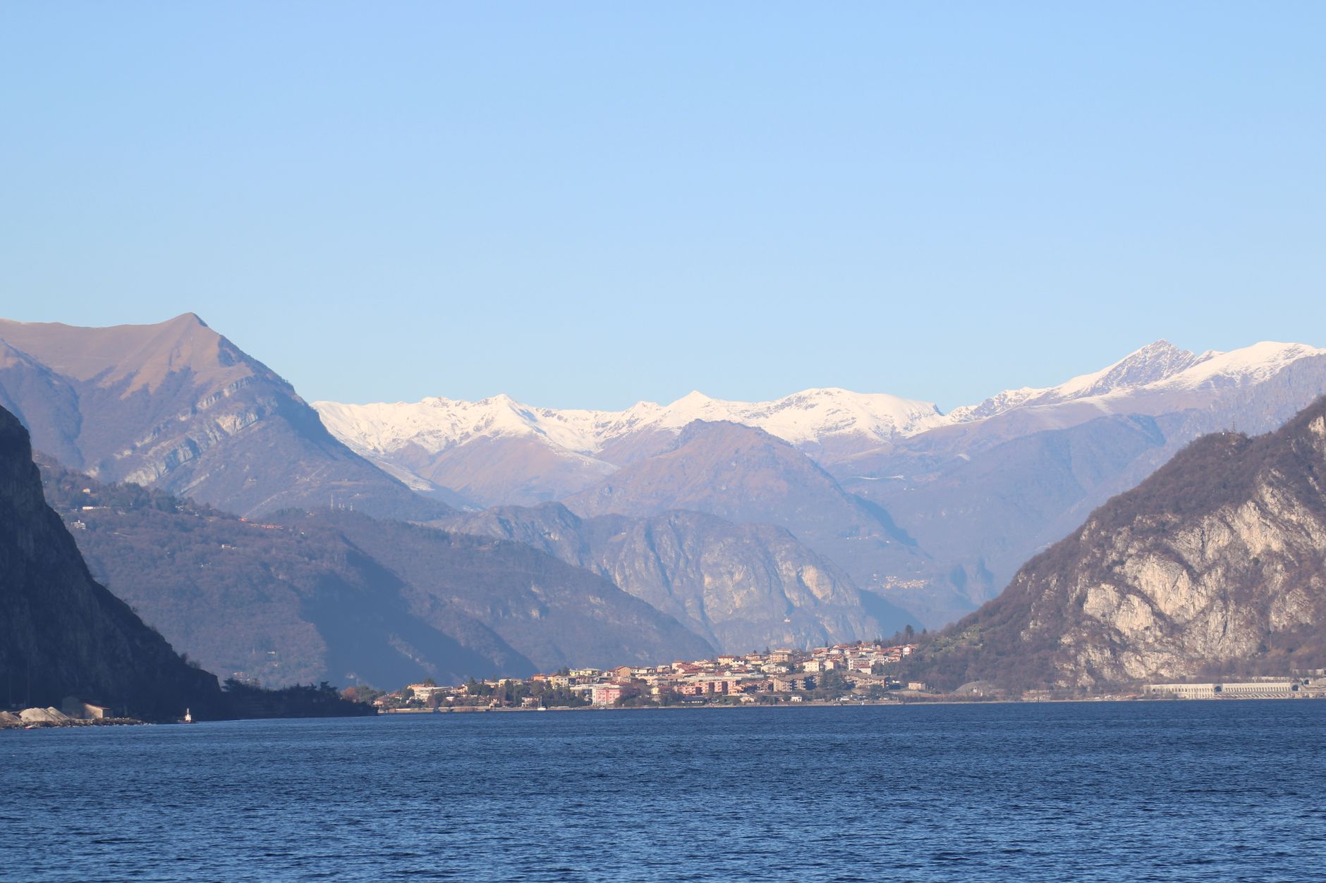 Beautiful landscape of Lake Como with snowy Alpine mountains in the background.