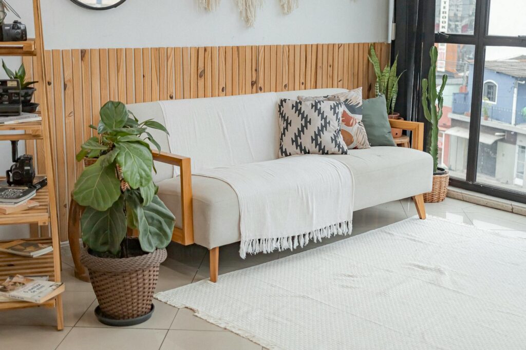 Bright living room with modern decor and lush indoor plants.