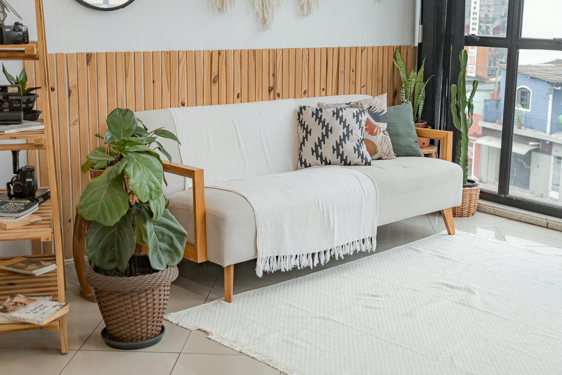 Bright living room with modern decor and lush indoor plants.