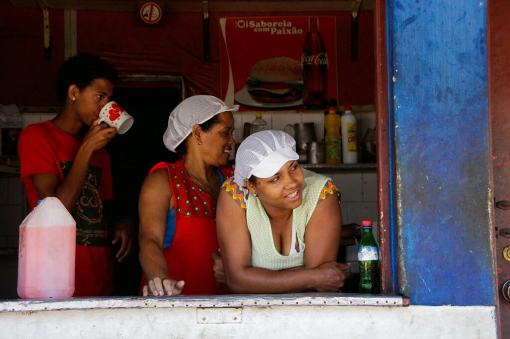 Three people enjoying a casual day at a café in Mindelo, Cape Verde.