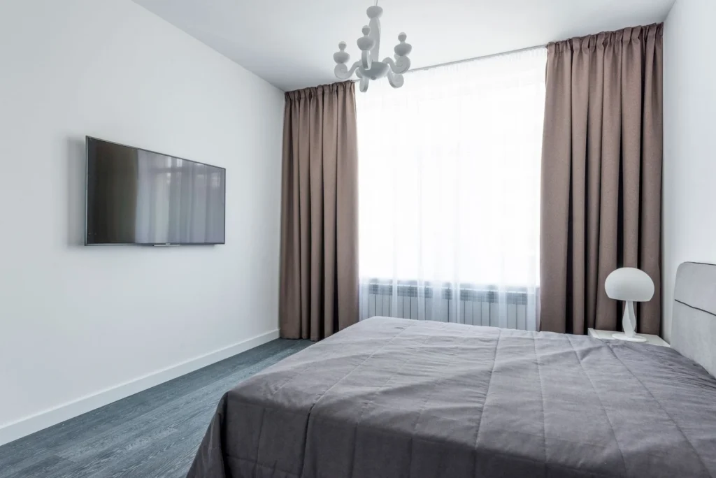 A minimalist bedroom featuring sleek furniture and a modern interior design.