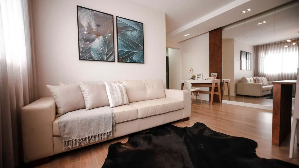 Cozy modern living room with a beige sofa, stylish artwork, and elegant decor.
