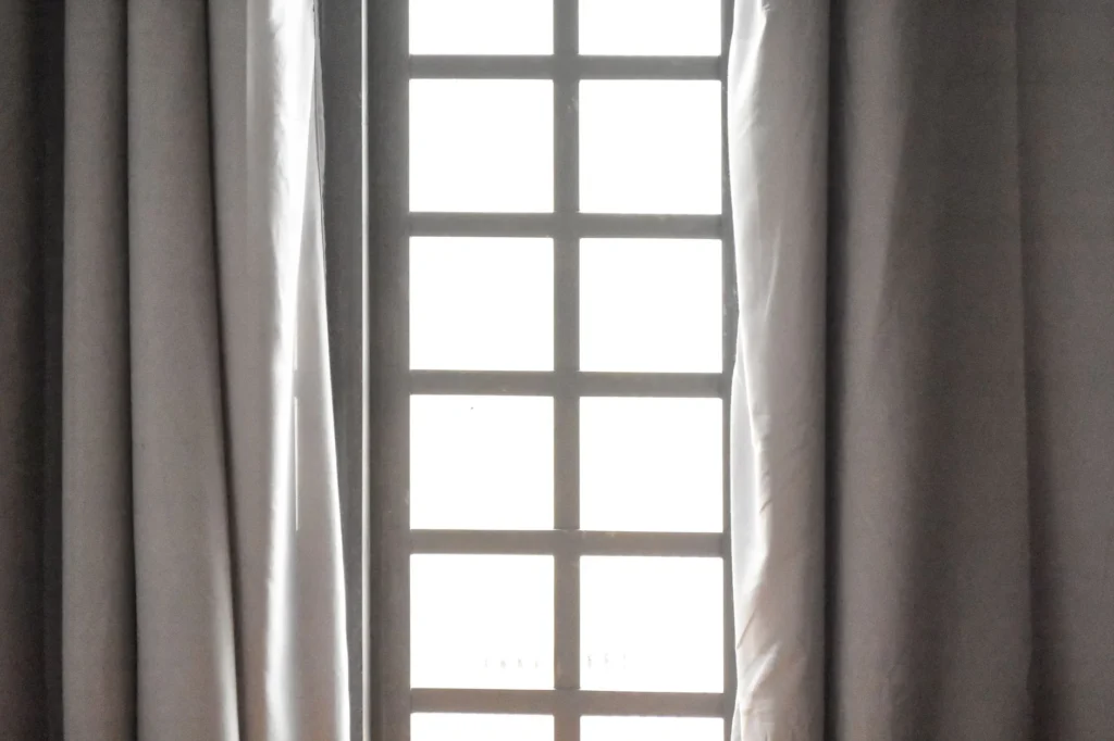 An elegant window with sheer curtains, capturing natural light and calm ambiance.