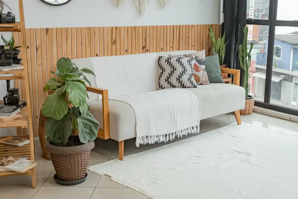 Bright living room with modern decor and lush indoor plants.
